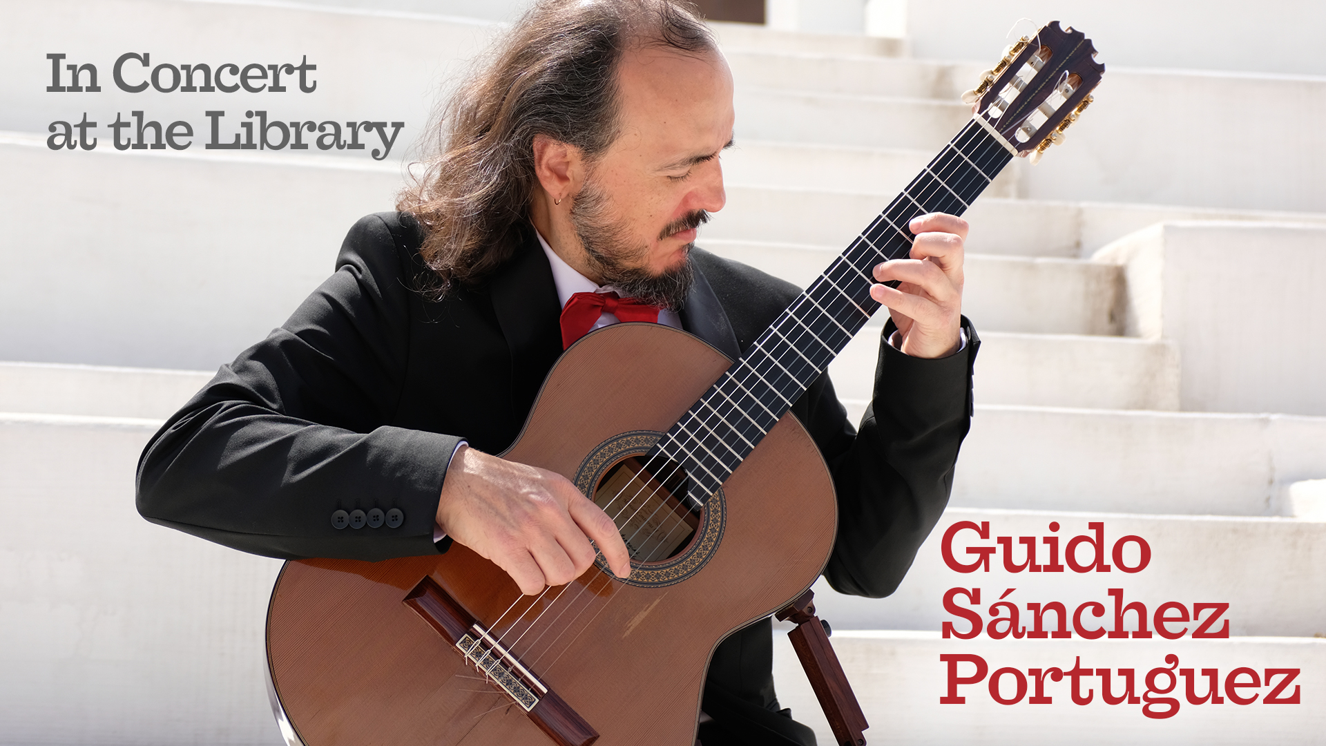 classical guitarist performing with white steps in background