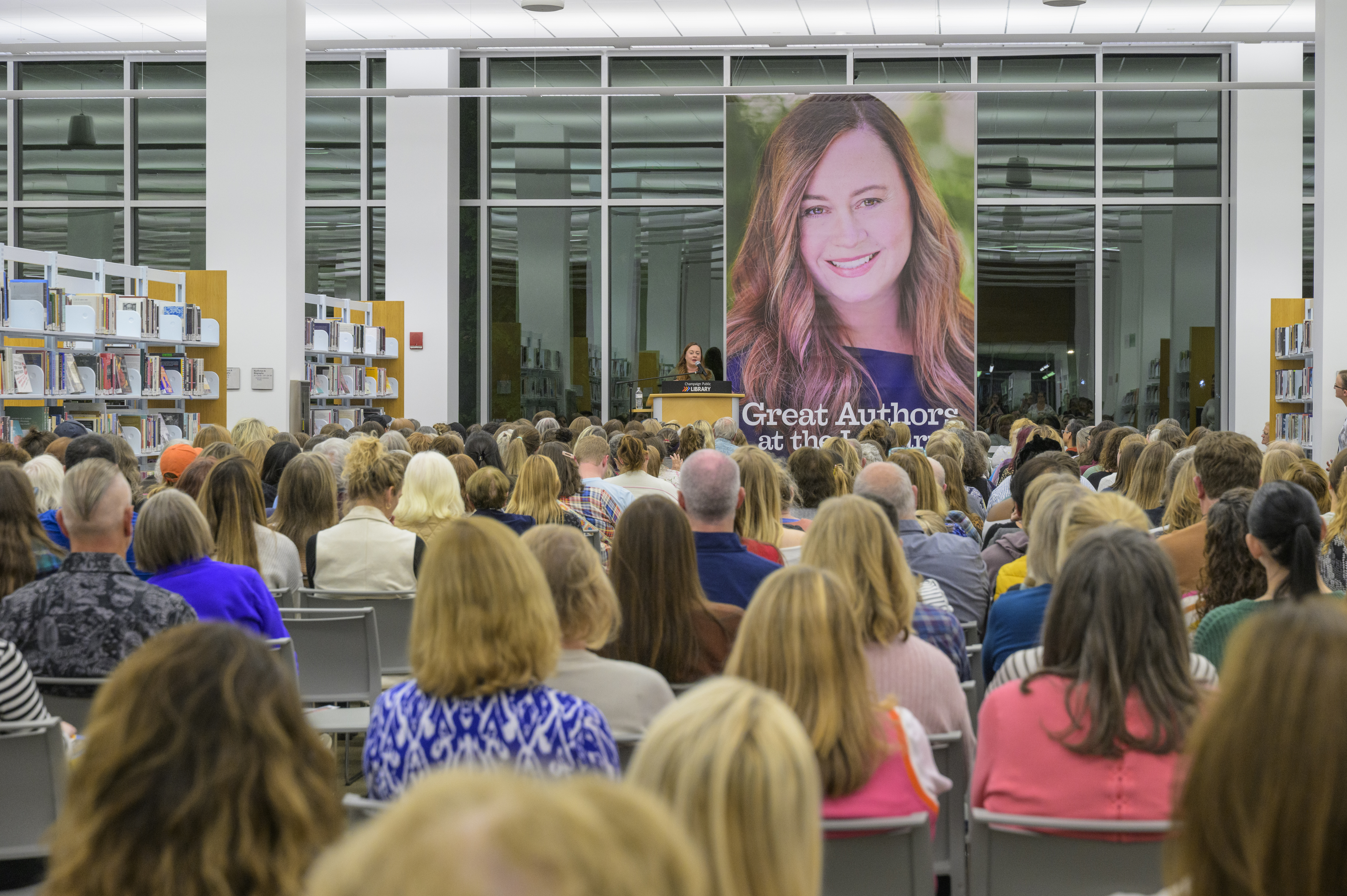 Author Shelby Van Pelt on a stage talking to an audience