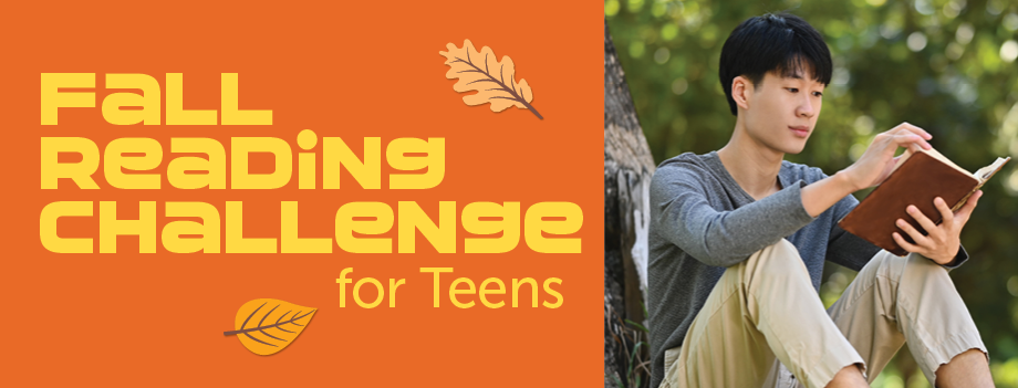 teen boy sitting by a tree reading a book
