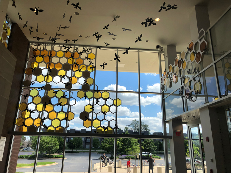 bee and honeycomb installation in library lobby