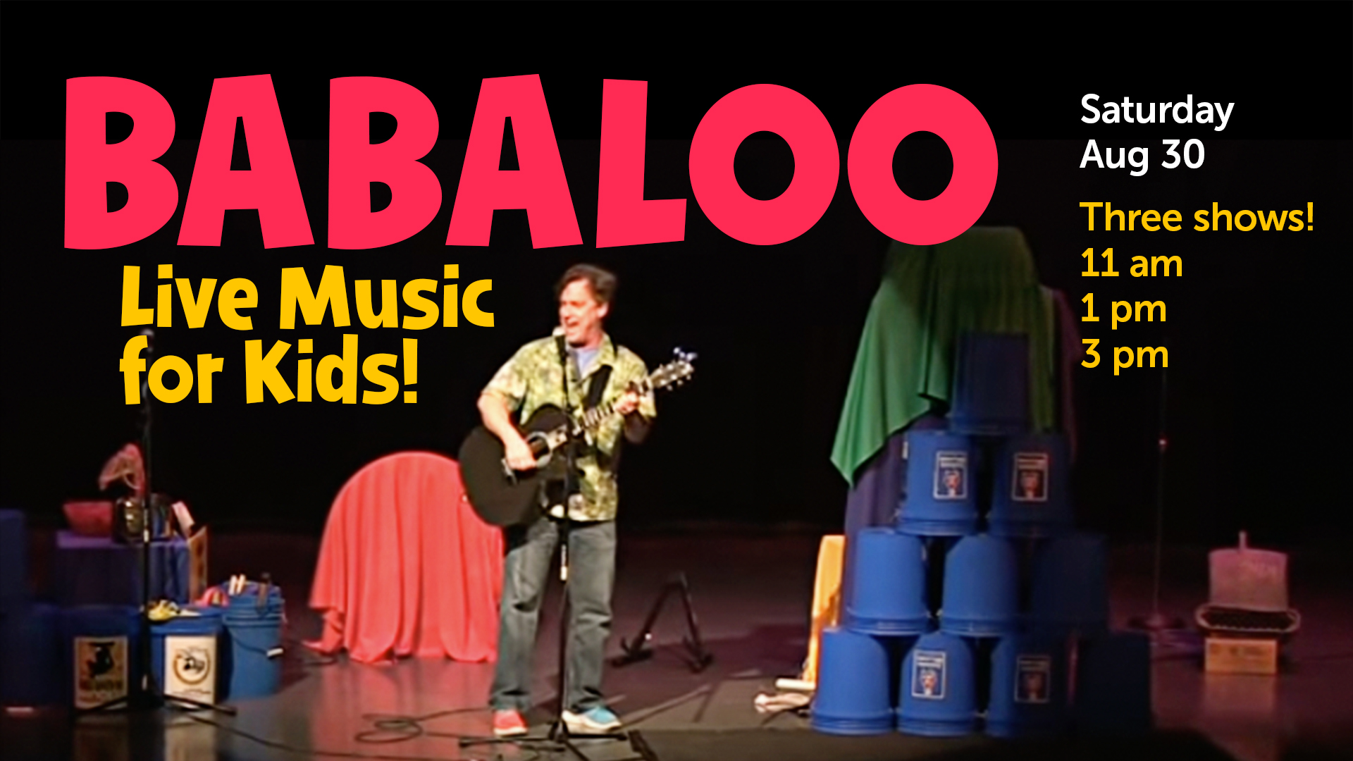 man playing guitar and singing on stage with event info text